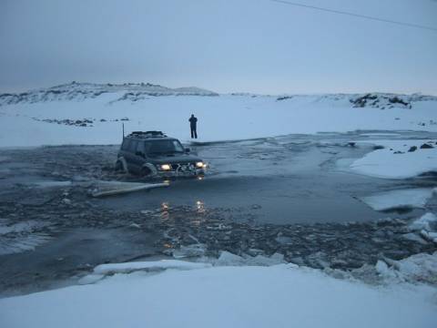 4x4 submerged in glacial river in f roads