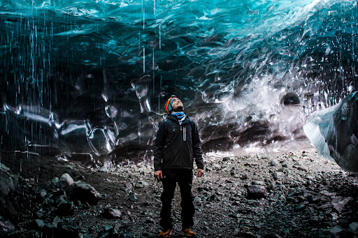 Man standing inside an ice cave in Iceland.